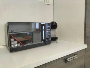a microwave sitting on top of a kitchen counter at Appartamento Muscatel in Piobesi dʼAlba +9 photos