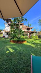 a large yard with a house in the background at Villa Samas in Galle