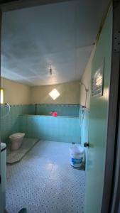 a bathroom with a toilet and a sink in a room at Homestay Rengganis Tengger in Ngadisari