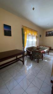 a living room with two couches and a table at Homestay Rengganis Tengger in Ngadisari
