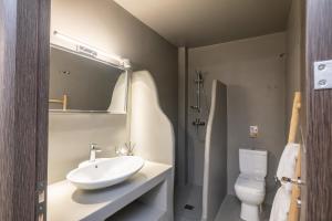 a bathroom with a sink and a toilet at Double M Adults Only in Ano Mera