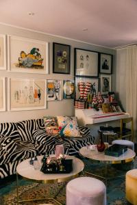 a living room with a zebra print couch and tables at Revolverhotel in Visby +71 photos