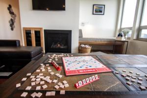a living room with a table with a board game at Ocean View of Rocky Shore! Yachats! Shorely Blessed in Yachats