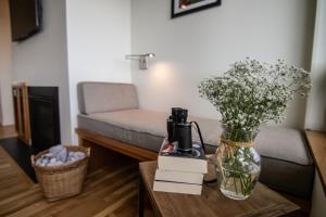 a living room with a couch and a vase of flowers on a table at Ocean View of Rocky Shore! Yachats! Shorely Blessed in Yachats