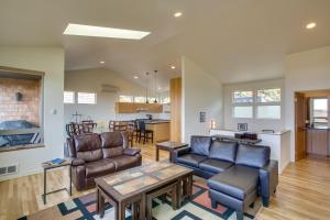 a living room with leather furniture and a kitchen at Ocean View of Rocky Shore! Yachats! Shorely Blessed in Yachats