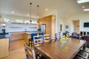 a kitchen and dining room with a wooden table and chairs at Ocean View of Rocky Shore! Yachats! Shorely Blessed in Yachats