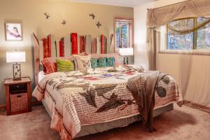 a bedroom with a large bed with colorful pillows at Hot Tub & Game Room in Large Ocean Front Home! Second Story in Holiday Beach +23 photos