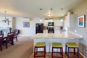 een keuken met een groot eiland in een kamer met stoelen bij Ocean Front, Amazing Views! Hot Tub! Sandy Seclusion in San Marine