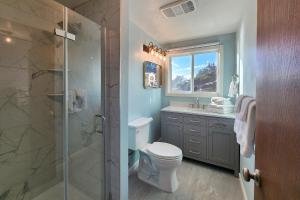 a bathroom with a toilet and a glass shower at Ocean Front 5 BR Home! Yachats, Walk to Everything! Rio Mar in Yachats +20 photos