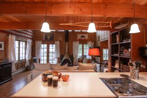 a kitchen and living room with wooden ceilings at Cute Cabin in Yachats! Short walk to rivers' edge! River Walk Cabin in Yachats +11 photos