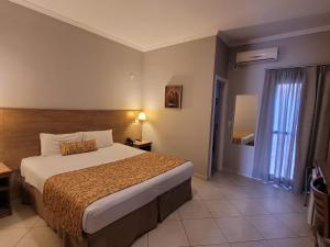 a hotel room with a bed and a window at Lazuli Hotel in Itatiba +42 photos