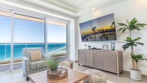 a living room with a view of the ocean at Encantame Towers Viento 1002 in Playa Encanto