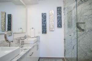 a white bathroom with a sink and a shower at Splash in The New Lazy River and Sleep In Luxury Encantame Towers Velero 2202 in Playa Encanto +22 photos