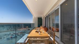 a dining room with a table and a swimming pool at Amazing two bedroom beach front condo W1105 in Playa Encanto