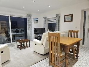 a living room with a couch and a table at Ty Nain in Bodorgan