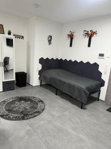 a bedroom with a bed and a rug on the floor at Ruhige Apartments an der Donau - Schwaben Living in Munderkingen