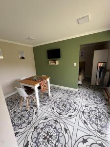 a living room with a table and a tile floor at Departamentos Turísticos MD in El Calafate
