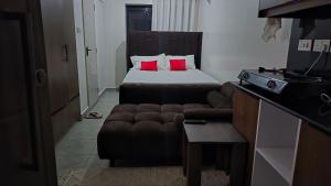 a hotel room with a bed and a couch at Serenity Brown Pad in Kiambu