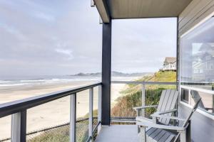 a balcony with a chair and a view of the beach at Ocean Front Condo, View of Lighthouse, Nye Beach! Nye Beacon in Newport