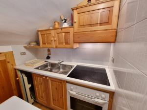 a kitchen with a sink and a stove at Villa Erica in Alba di Canazei +2 photos