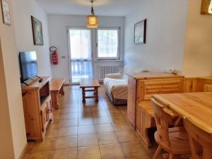 a living room with a couch and a table at Villa Erica in Alba di Canazei