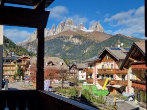 a view from a balcony of a town with mountains at Villa Erica in Alba di Canazei