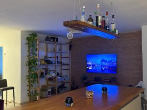 a living room with a table and a tv at חניתה 40 חיפה in Haifa