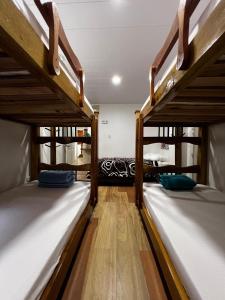 a room with three bunk beds in a room at Elizabetha Hostal in Salento