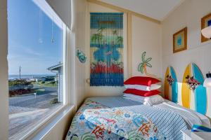 a bedroom with a bed and a window with surfboards at Ocean Views and Short Walk to Sandy Beach! Changes in Attitude in Bayshore +26 photos