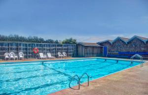 a large swimming pool with chairs at Ocean Views and Short Walk to Sandy Beach! Changes in Attitude in Bayshore