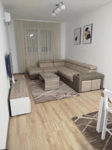 a living room with a couch and a tv at Apartman Lazar in Ruma