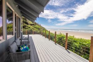 a porch with a bench and a view of the beach at Ocean Front on Miles of Sandy Beach! Boho Shores in San Marine