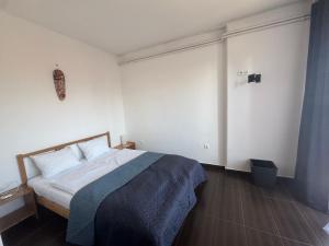a bedroom with a bed with a blue blanket at Bestapartman in Balatonboglár +49 photos