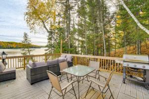 a deck with a table and chairs and a grill at All-Season Adventures! Chicaugon Lakefront Gem in Mapleton