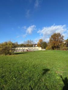a field of green grass with a building in the background at Ruhige Apartments an der Donau - Schwaben Living in Munderkingen
