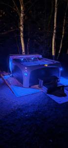 a pool table with blue lights in a yard at night at Glamping chalet on campsite Boat Lac Naviguable in Saint-Michel-des-Saints