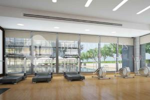a gym with several chairs and a large window at Bloomfileds Cozy Stu in Park View in Mushayrib