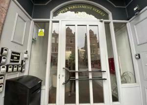 an entrance to a building with a glass door at Heart of Notts, Spacious Studio, Great City Views in Nottingham