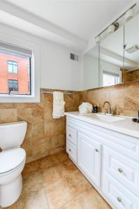 a bathroom with a toilet and a sink at Modern 3BR Townhouse with Private Rooftop & Parking Minutes to NYC in Hoboken