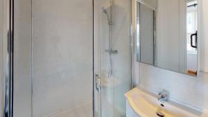 a bathroom with a glass shower and a sink at Heart of Notts, Spacious Studio, Great City Views in Nottingham +19 photos