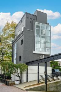 a building with a sign that reads at Modern 3BR Townhouse with Private Rooftop & Parking Minutes to NYC in Hoboken