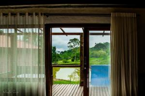an open window with a view of a mountain at Refúgio Caminho dos Ipês in Passa Vinte