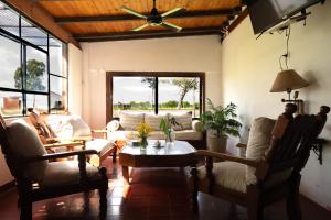 a living room with a couch and a table at Yellow Cardinal Lodge in Curuzú Cuatiá