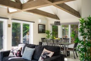 a living room with a couch and a table at Nature, hot tub and relaxation at its best! in Val des Monts