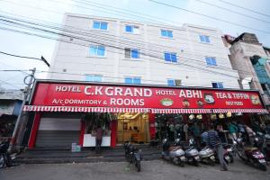 a hotel cerk grand hotel with motorcycles parked in front of it at Hotel CK Grand in Jāmb