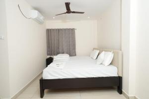 a bedroom with a bed with a ceiling fan at Hotel CK Grand in Jāmb