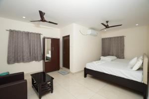 a bedroom with a bed and a window with two ceiling fans at Hotel CK Grand in Jāmb