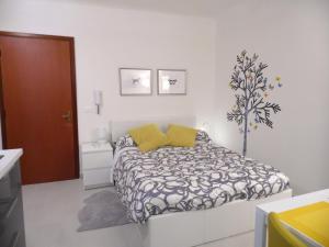 a bedroom with a bed with a black and white comforter at Paganini in Lucca