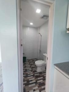 ein Badezimmer mit WC und kariertem Boden in der Unterkunft M&S Cabina in Alburquerque