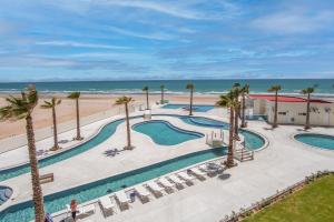 an aerial view of a resort with palm trees and a beach at Cozy beach front getaway Encantame Towers E304 in Playa Encanto